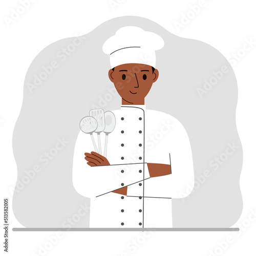 Smiling chef holds a kitchen cutlery set in his hand. profession.