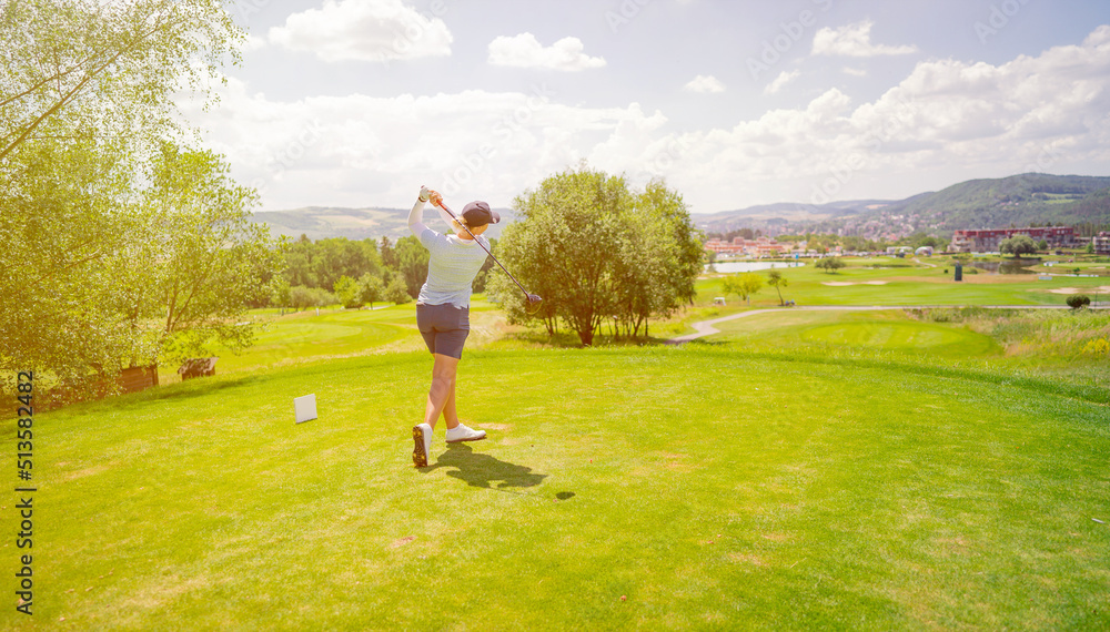 Golfer sport course golf ball fairway. People lifestyle woman playing game golf and hitting go on green. Copy space banner Golfer sport course golf ball fairway. People lifestyle woman playing game golf and hitting go on green. Copy space banner