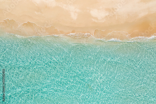 Relaxing aerial beach scene, summer vacation holiday template banner. Waves surf with amazing blue ocean lagoon, sea shore, coastline. Perfect aerial drone top view. Peaceful bright beach, seaside 