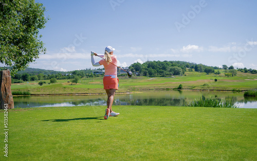 Golfer sport course golf ball fairway. People lifestyle woman playing game golf tee of on the green grass. Professional golf female player game shot in summer. Healthy and Sport outdoor