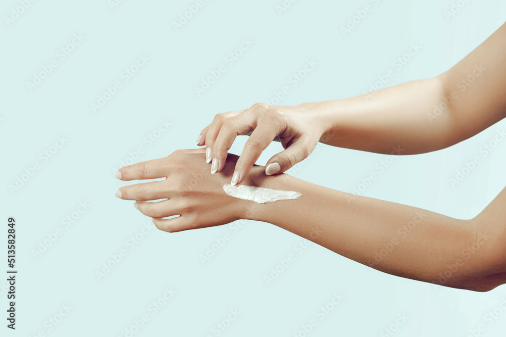 Beautiful Woman Hands. Female Hands Applying Cream, Lotion. Spa and Manicure concept. Soft skin, skincare concept. Hand Skin Care.