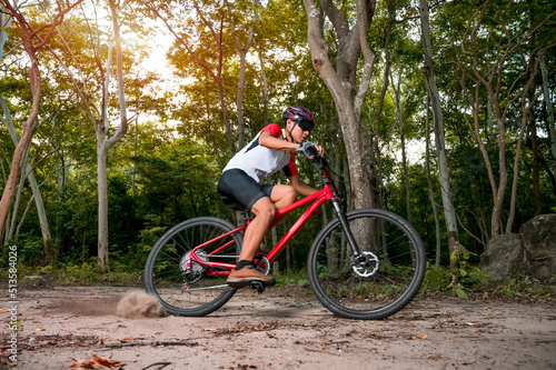 Mountain bikers ride MTB, mountain bike downhill to the extreme. Asian man rides MTB, mountain bike downhill in the wild to extremes. Extreme Sport and MTB, mountain bike downhill Concept.