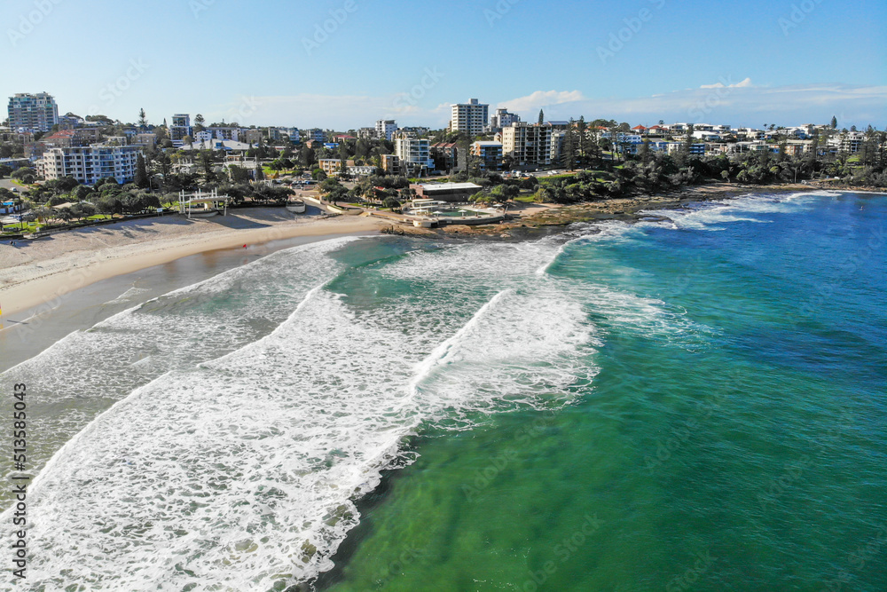 Stunning coastline of Kings Beach, during autumn season with aerial view of the beach below and buildings in view. 