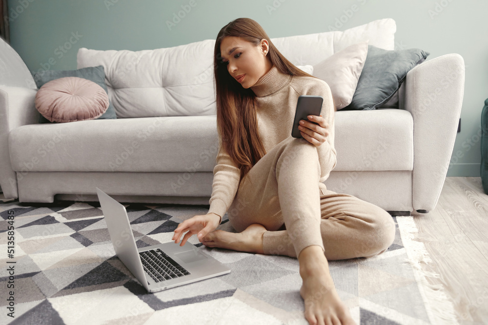 Happy young woman sitting on the floor and usings laptop. girl shopping online. Happy young woman sitting on the floor and usings laptop. girl shopping online.