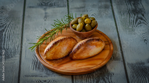 La salteña es un tipo de empanada de origen boliviano , ​ comido como una merienda jugosa y rellena con carne, pollo u otras carnes, huevo duro, especias, y otros ingredientes, cocida al horno