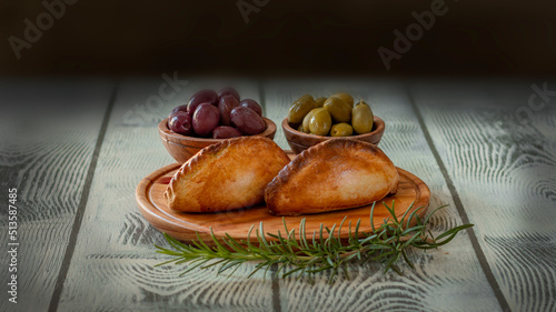 La salteña es un tipo de empanada de origen boliviano , ​ comido como una merienda jugosa y rellena con carne, pollo u otras carnes, huevo duro, especias, y otros ingredientes, cocida al horno