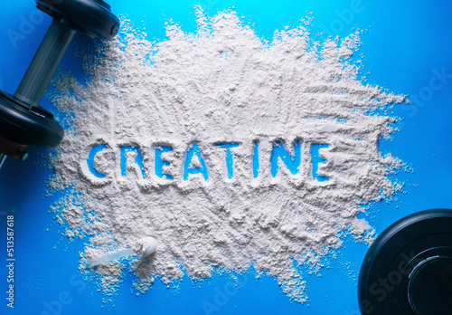 Scattered powder with the word creatine written on it on a blue background.