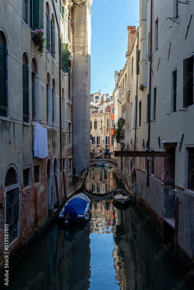 Narrow canal in Venice on a summer morning