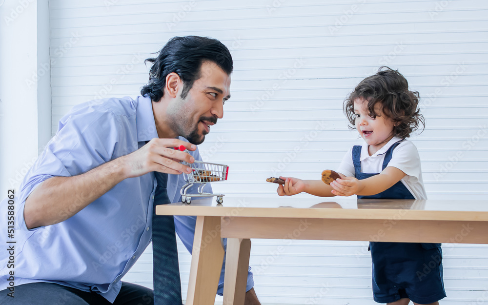 Caucasian handsome father taking care, playing toys with his little cute daughter on floor in cozy living room at home after work with happiness. Family and Education Concept. Caucasian handsome father taking care, playing toys with his little cute daughter on floor in cozy living room at home after work with happiness. Family and Education Concept.