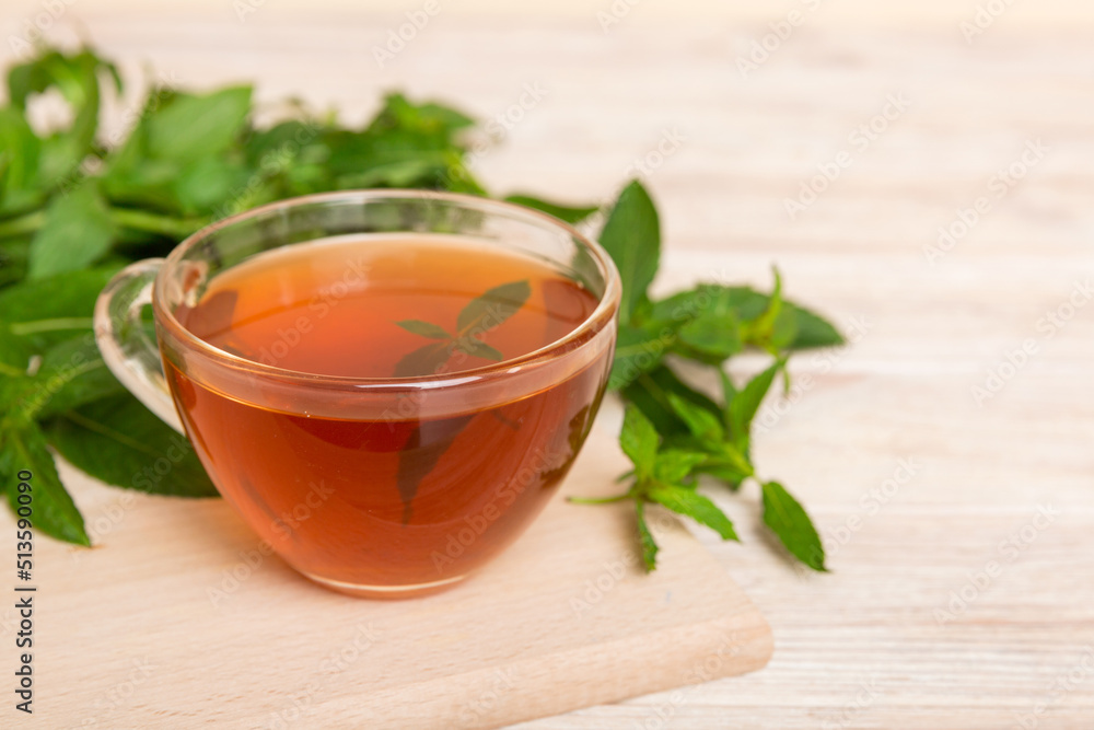 Cup of mint tea on table background. Green tea with fresh mint top view with copy space Cup of mint tea on table background. Green tea with fresh mint top view with copy space