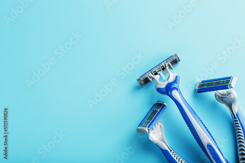 Blue shaving machines in a row on a blue background with ice cubes