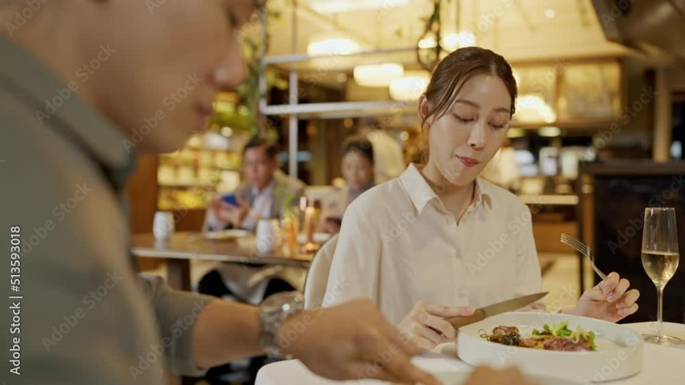 Asian couple having dinner at an upscale restaurant. They enjoy with dinner together. Asian couple having dinner at an upscale restaurant. They enjoy with dinner together.