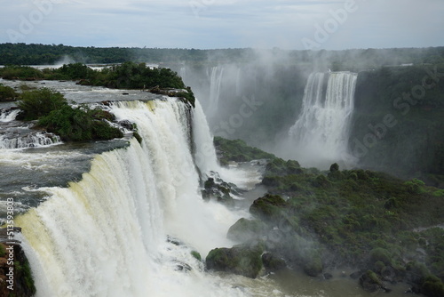 The photo shows a stunning view from the top of the Iguazu Falls — a complex of 275 waterfalls on the Iguazu River, located on the border of Brazil and Argentina.