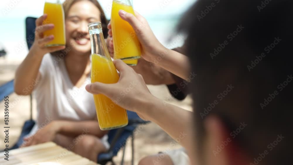 Group of people family camping on the beach drinking juice refreshment together enjoy on the summer travel resting sitting outside tent people lifestyle on the weekend. Group of people family camping on the beach drinking juice refreshment together enjoy on the summer travel resting sitting outside tent people lifestyle on the weekend.