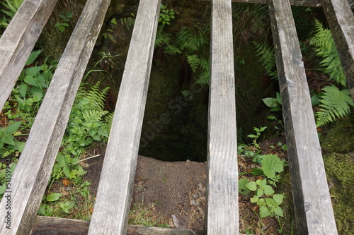A deep well for water carved into the rock.