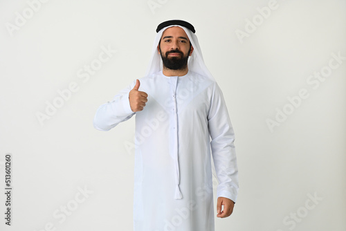 Happy Arab Emirati man thumbs up isolated on white background wearing traditional. Arabian Muslim man excited for new business