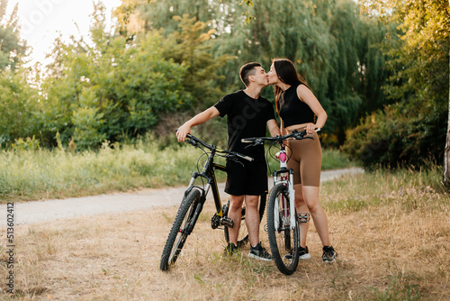 young couple riding a bicycle in the park