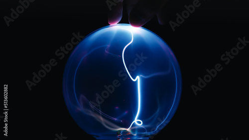 Touching Plasma Ball on black background