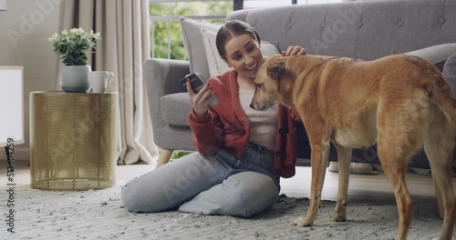 Happy woman using phone and credit card to do online shopping and banking while bonding with her mixbreed africanis pet dog. Consumer spending money with convenience from the comfort of her home photo