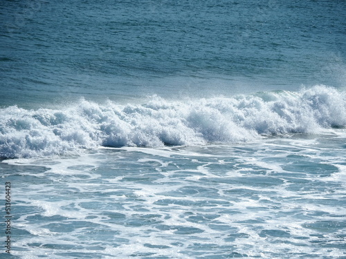 White waves crushing on blue sea