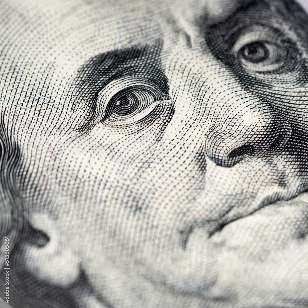 Portrait of Benjamin Franklin on a hundred dollar bill. Macro photography. Square photography. Focus on the eye.