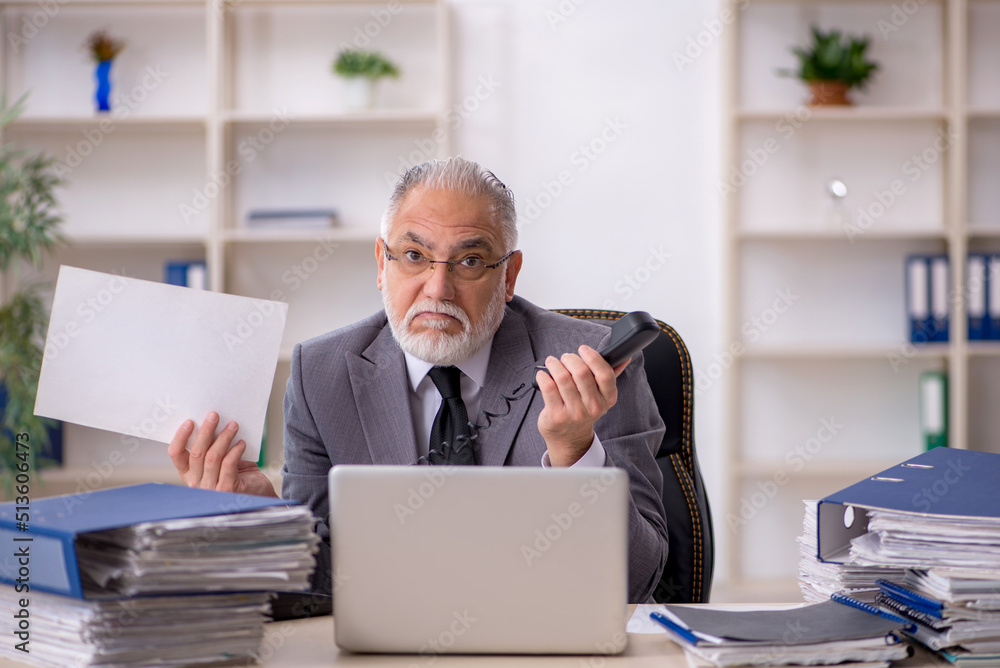 Old male employee and too much work in the office Old male employee and too much work in the office