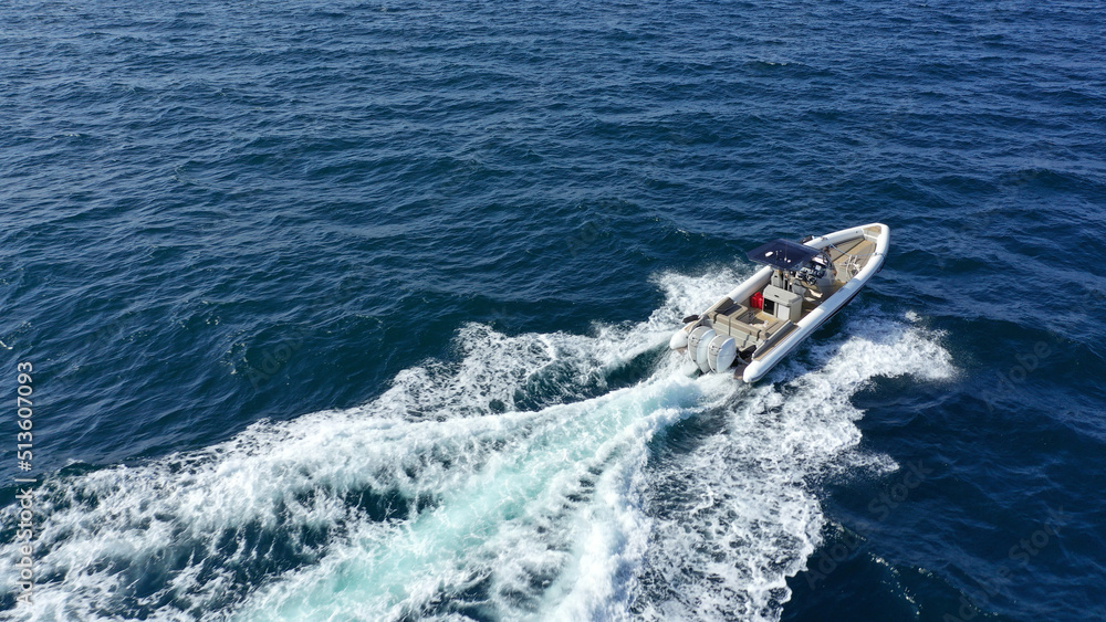 Fototapeta premium Aerial drone photo of luxury rigid inflatable speed boat cruising in high speed in Aegean deep blue sea, Greece