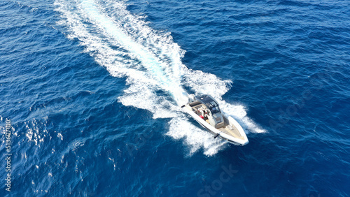 Aerial drone photo of luxury rigid inflatable speed boat cruising in high speed in Aegean deep blue sea, Greece © aerial-drone