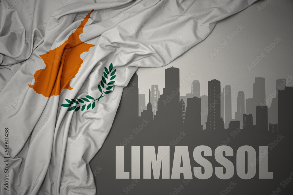 abstract silhouette of the city with text Limassol near waving national flag of cyprus on a gray background.
