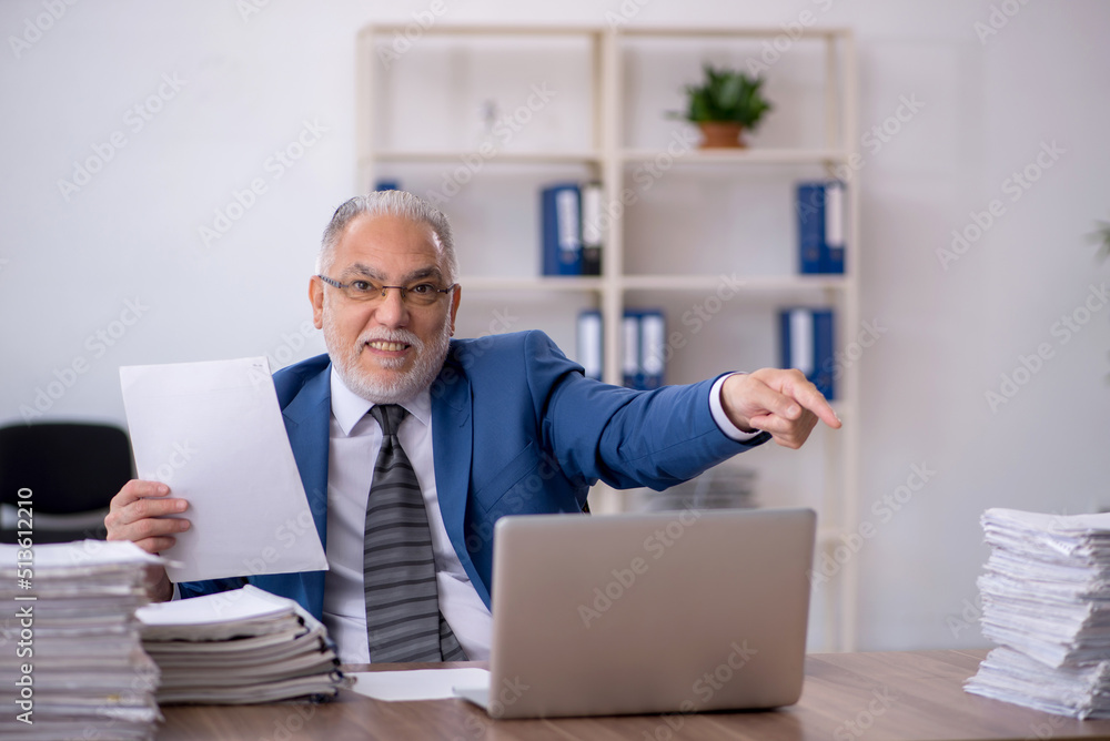 Old male employee and too much work in the office Old male employee and too much work in the office