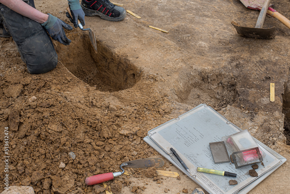 archaeologist kneeling at an excavation in Erritsø