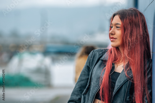 portrait of red-haired girl with flowing hair or long hair on the street