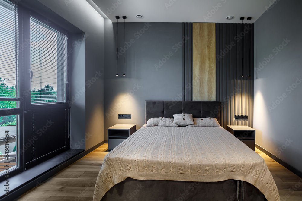 Modern and loft bedroom with dark and grey style. Dark headboard and wooden floor with glass window Modern and loft bedroom with dark and grey style. Dark headboard and wooden floor with glass window