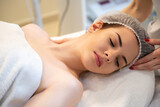 Young woman having head massage in beauty salon