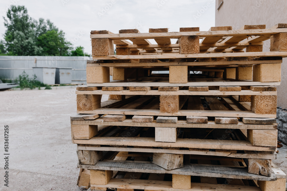 Wooden pallets lie on top of each other on the street Wooden pallets lie on top of each other on the street