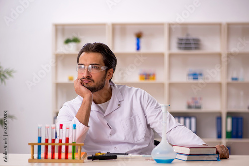 Young male chemist working at the lab