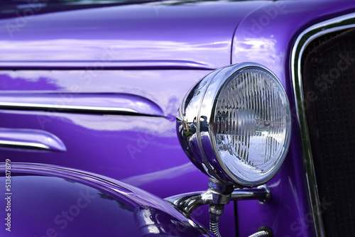 Closeup of headlight of purple retro vintage car © Julia