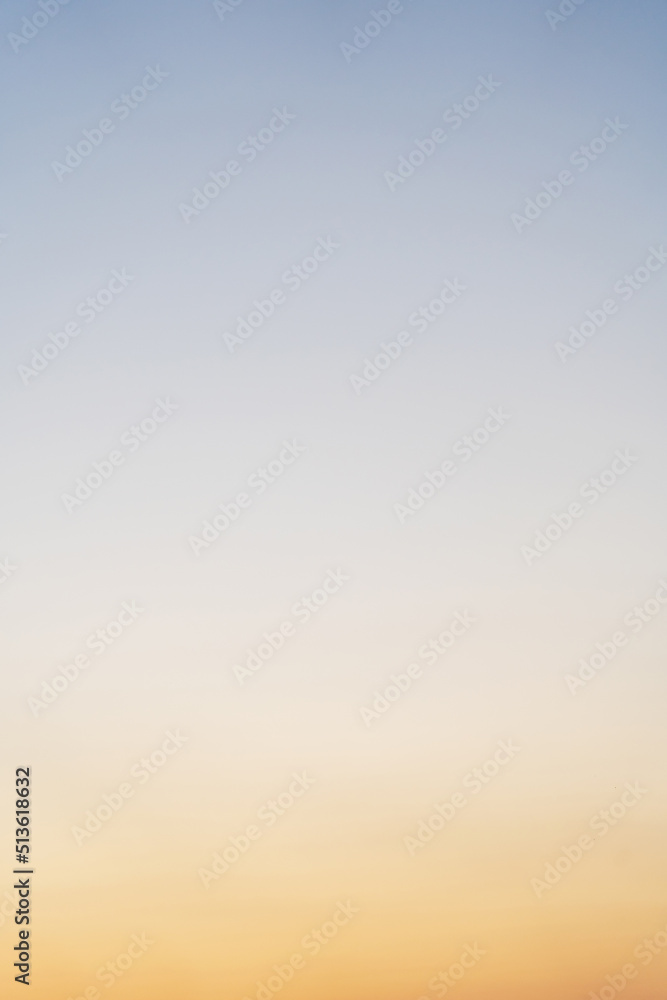 Sunset, sunrise gradual color of sky. Smooth orange blue gradient of dawn sky. Vertical background of heaven at early morning