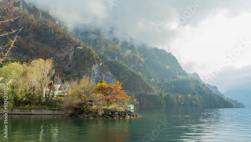 Time lapse view on the lake and mountains. Clouds dancing around mountains. Lake Lucerne, Vierwaldstättersee, Sisikon, Canton Uri, Switzerland. photo