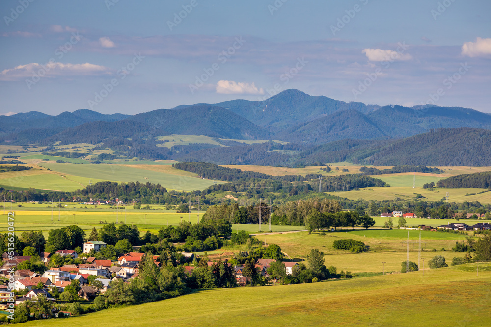 Sunny spring rural landscape, the village in the middle of fields and meadows with mountains in the background. Turiec Valley in Slovakia, Europe.