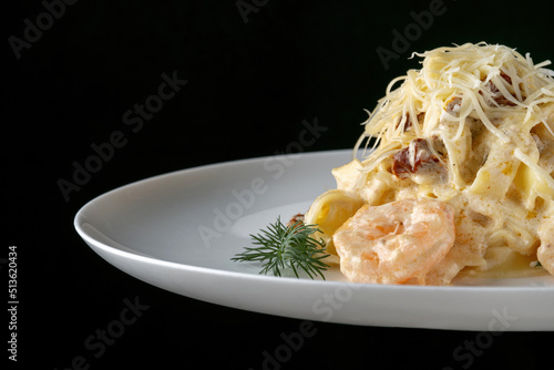 A plate of delicious shrimp alfredo with garlic and cream sauce over pasta.