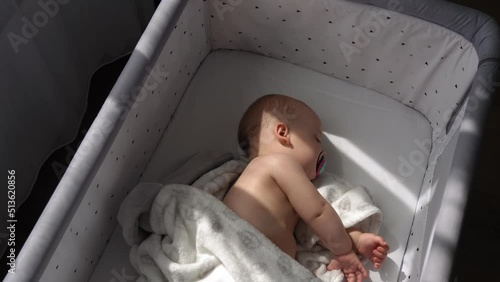 Top View face of Newborn Nnaked Sleeping Little Small Infant Baby Boy Lying On Side On Soft White Banket On Bed At Home. Infancy, Childhood, Development, Medicine, Health, Love, Care, Comfort Concept photo