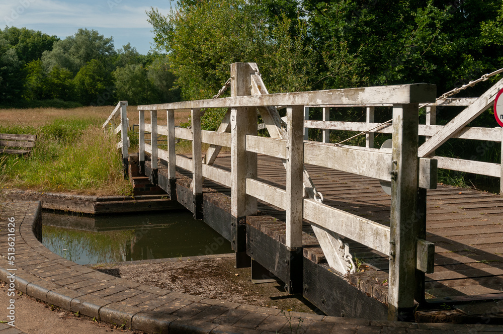 wooden turning manual foot bridge over the river canal wooden turning manual foot bridge over the river canal
