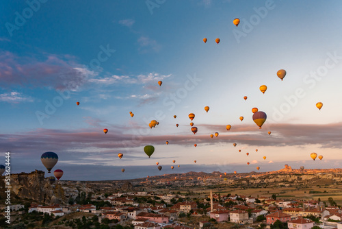Several ballons flying over the sky during sunrise at Cappadocia