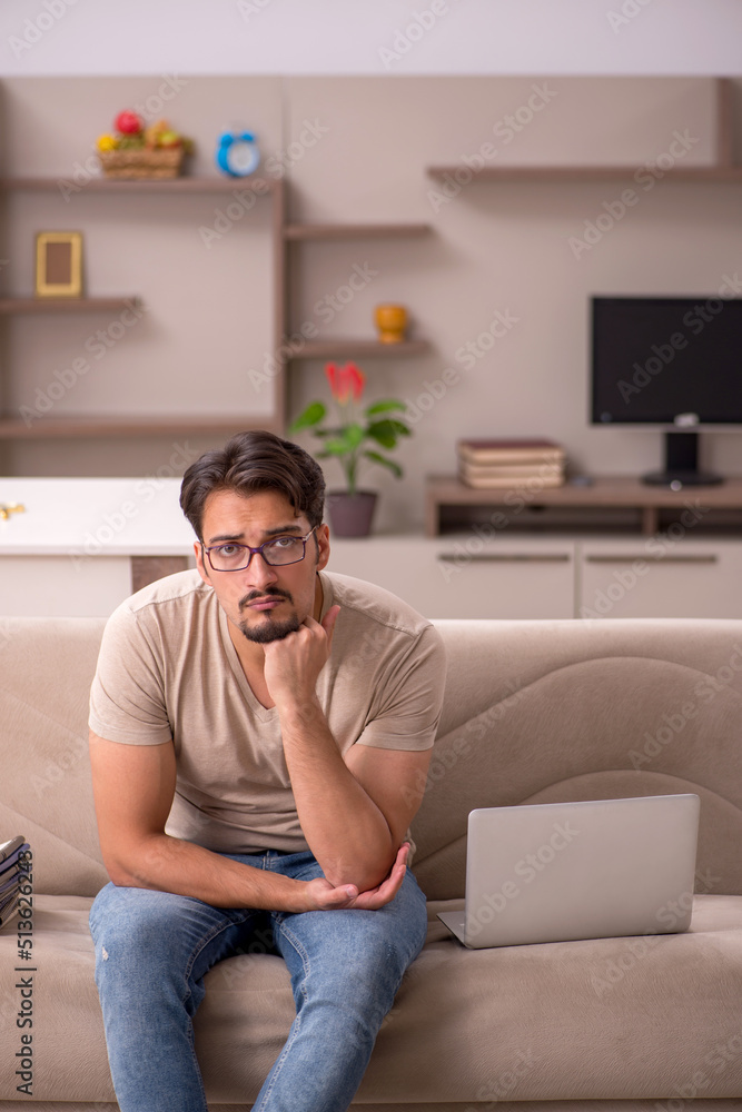 Young male employee working from house