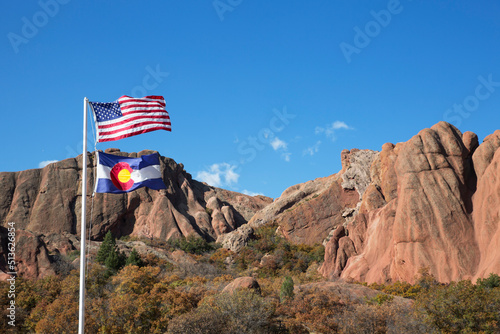US flag in front of red rock formation at Roxborough State Park in Colorado photo