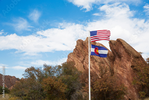 US flag in front of red rock formation at Roxborough State Park in Colorado photo