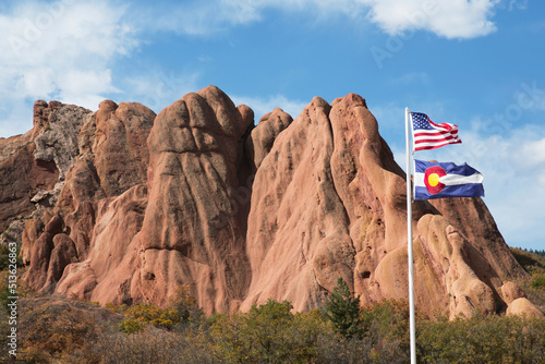 US flag in front of red rock formation at Roxborough State Park in Colorado