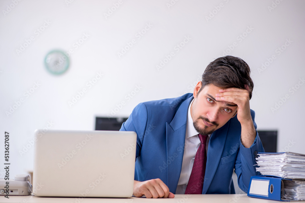 Young male employee working in the office Young male employee working in the office