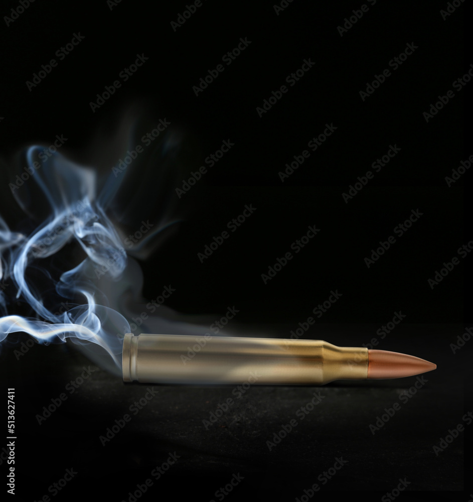 One bullet with smoke on black background One bullet with smoke on black background